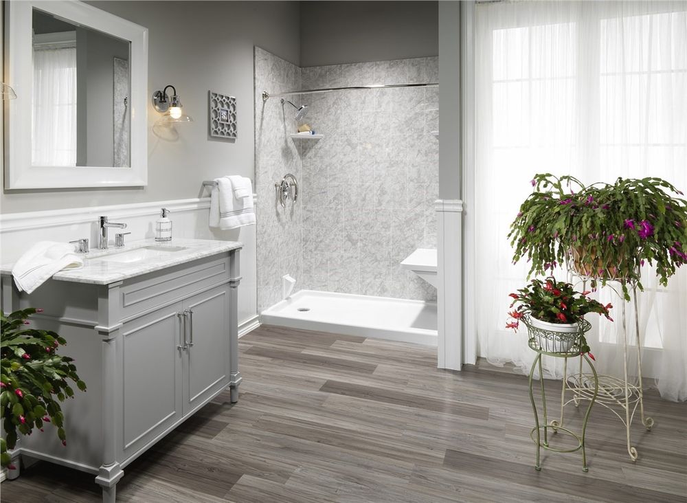 Carrara marble look walk in shower with a grey vanity