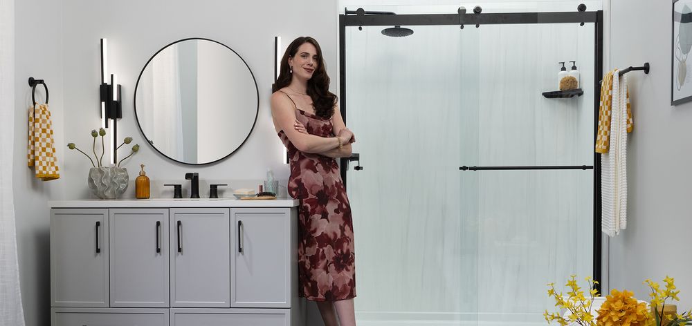 Modern walk in shower with a black barn style sliding glass door